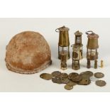 A miner's skullcap, together with a collection of colliery tokens and eight miniature Davy lamps.