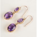 A pair of amethyst earrings set in gold.