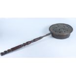 A Flemish brass warming pan, late 17th/early 18th century, with a later turned wood handle,