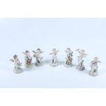 A Sitzendorf porcelain seven piece orchestra, comprising of seated winged cherubs,