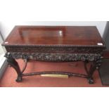 A Chinese hardwood centre table, with an unusual lift up lift above a carved frieze,