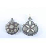 Two Persian white metal powder flasks, the largest with inlaid bone panels and neck, length 25cm,