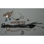 A silver bangle set an agate cabochon, a faceted jet bead and heart necklace,
