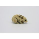 A ivory netsuke carved as a rabbit, early 20th century, height 1.9cm, width 3.4cm.