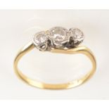 An 18ct yellow gold diamond crossover ring.