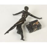 An Art Deco bronze figure of a scantily clad dancing lady, on a stepped, veined marble base,