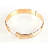 A 9ct gold bangle, 12.1g.