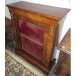 A Victorian inlaid walnut display cabinet, with gilt metal mounts flanking a single door,