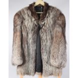 A Georgiou lady's silver fox three quarter length fur jacket, black satin lining, size 12/14,
