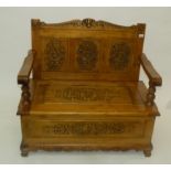 A Lindenwood floral carved settle, with a triple panelled back,