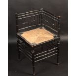 An Arts and Crafts ebonised Sussex corner chair designed by Ford Madox Brown for Morris & Co the