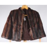 A lady's mink cape, with dark brown silk lining, length 50cm, size 6/8.