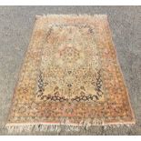 A fine quality Persian Ghom rug, the ivory field with a central lobel medallion with a scrolling,