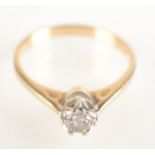 A 9ct yellow gold solitaire diamond ring.