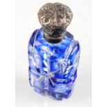 A Victorian blue glass overlay perfume bottle with embossed silver hinged lid.