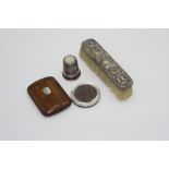 A miniature silver mounted photograph frame, a giant thimble, silver topped and three other pieces.