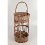 A two tier wicker basket, height 67cm, diameter 26cm.