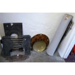 A pair of cast iron fire fronts, a cast iron fire surround, grate, two brass trays and a rug