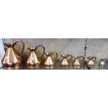 A set of seven graduated copper harvest measures, one gallon to one-eighth gill