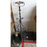 A brass coal helmet with shovel, a wrought iron lamp stand with wrought iron footman stand (3)