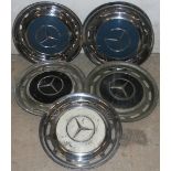 A set of Mercedes Benz chrome and blue enamel hub caps, diameter 39 cm, a pair of black examples and