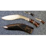 A Kukri in scabbard with skinning knives