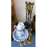 A brass companion set, two pairs of brass candlesticks, blue and white jug and bowl set and a