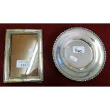 A silver photograph frame Birmingham 1917 of rectangular form and a sterling silver dish