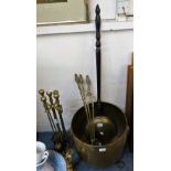 A large brass log bin on raised feet together with companion set and copper warming pan