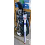 A golf bag, trolley, set of clubs, umbrella and Klikka tube