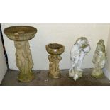 Two bird baths together with two stone garden figures, one with head detached (4)