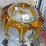 An amber and clear glass ceiling shade unusually incorporating a fly within the glass