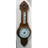A carved walnut cased combined aneroid barometer and thermometer.