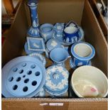 A box of Wedgwood blue Jasperware including flower vase, candlestick,plates etc.