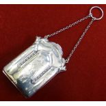 A silver purse Birmingham 1917 of shaped form with embossed and engraved form