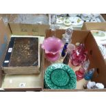 A box of glass and china including cranberry glass, Nao figurine, decanters, leaf moulded plates,