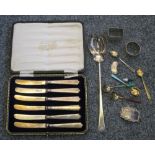 A silver set of butter knives, Sheffield 1920, case, five silver gilt and enamel coffee spoons,