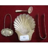 A silver shell butter dish, London 1986, a George III silver pair of sugar tongs, a silver sugar