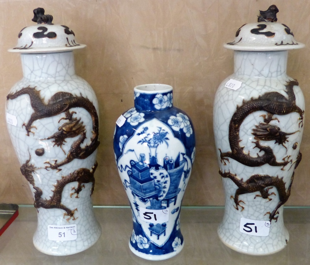 A pair of Chinese crackle glazed temple jars and covers, with dragons in relief, together with a