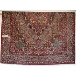 A multi-coloured Persian patterned rug, approximately 244cm x 350cm