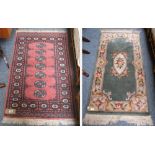 A Chinese green rug, central motif and border, approximately 160cm x 76cm together with a Bokhara