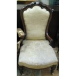 A Victorian mahogany armchair with undulating top rail and carved turned front legs