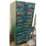 A multi-coloured twelve drawer plan chest