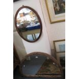 A mahogany framed oval wall mirror, together with a bamboo effect framed demi-lune wall mirror (2)