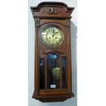 An oak cased wall clock