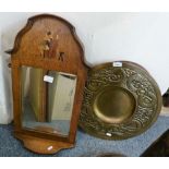 An oak framed bevel edged wall mirror with a bottom shelf and inlay of a cello player together