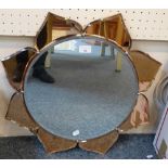 An Art Deco style wall mirror in the form of a flower head with peach glass petals