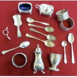 A small collection of silver items, mustard spoons, egg cup, napkin rings etc.
