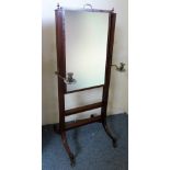 A Regency mahogany cheval mirror, with two adjustable brass sconces, the oblong plate with rise-