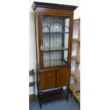 An Edwardian mahogany tall and narrow display cabinet with astragal glazed door and cupboard base